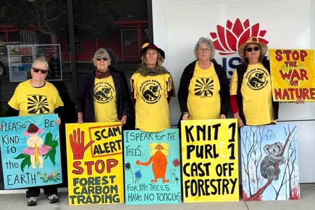 5 Knitting Nannas stand with placards in front of NSW government office